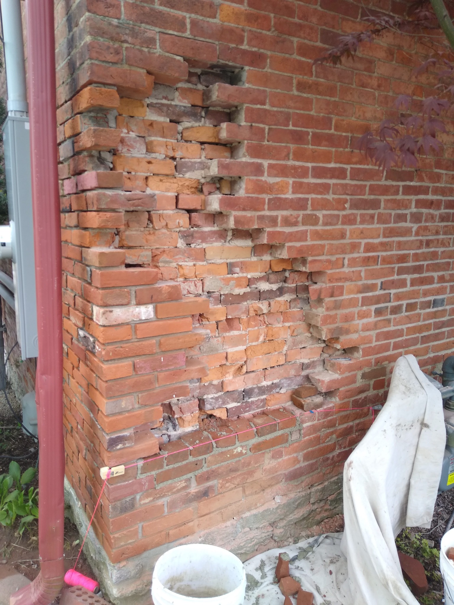 Historic Brick Wall Reconstruction: Deteriorated masonry removed